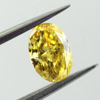 GIA Oval Fancy Vivid Orangy Yellow Diamond, 0.51 carat