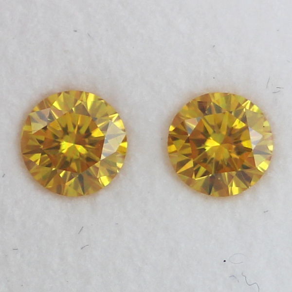 Pair of Fancy Vivid Orangy Yellow Diamond, Round, 0.60 carat, SI2