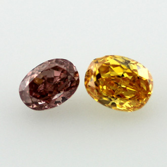 Pair of Vivid Yellow Orange and Deep Orangy Pink Diamond, Oval, 0.51 carat, SI1